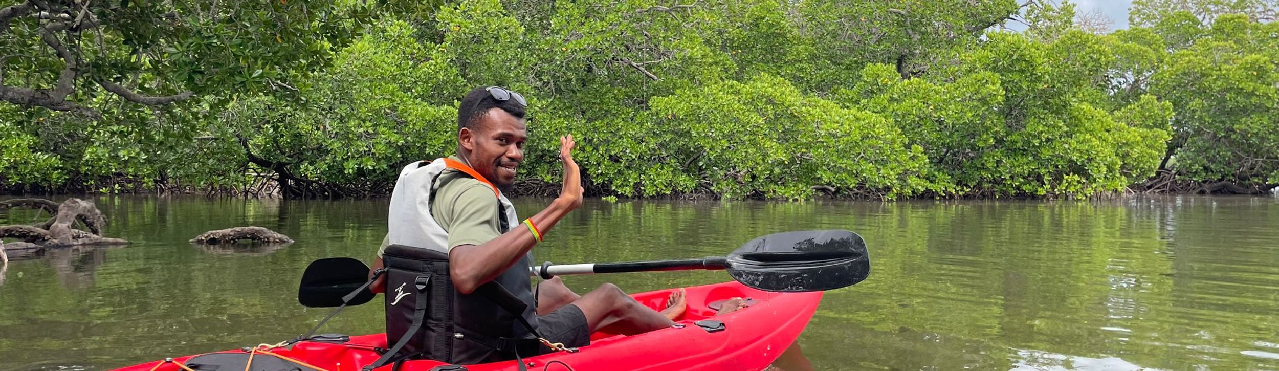 two explorers kayaking in the mangroves
