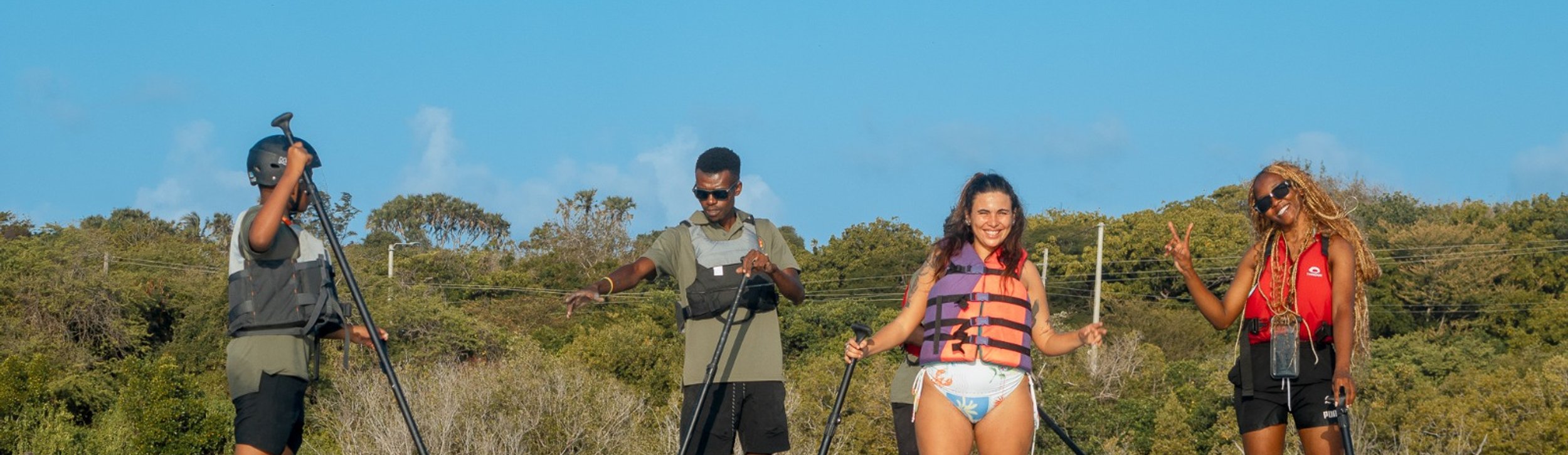An explorer on a paddle board at sunset