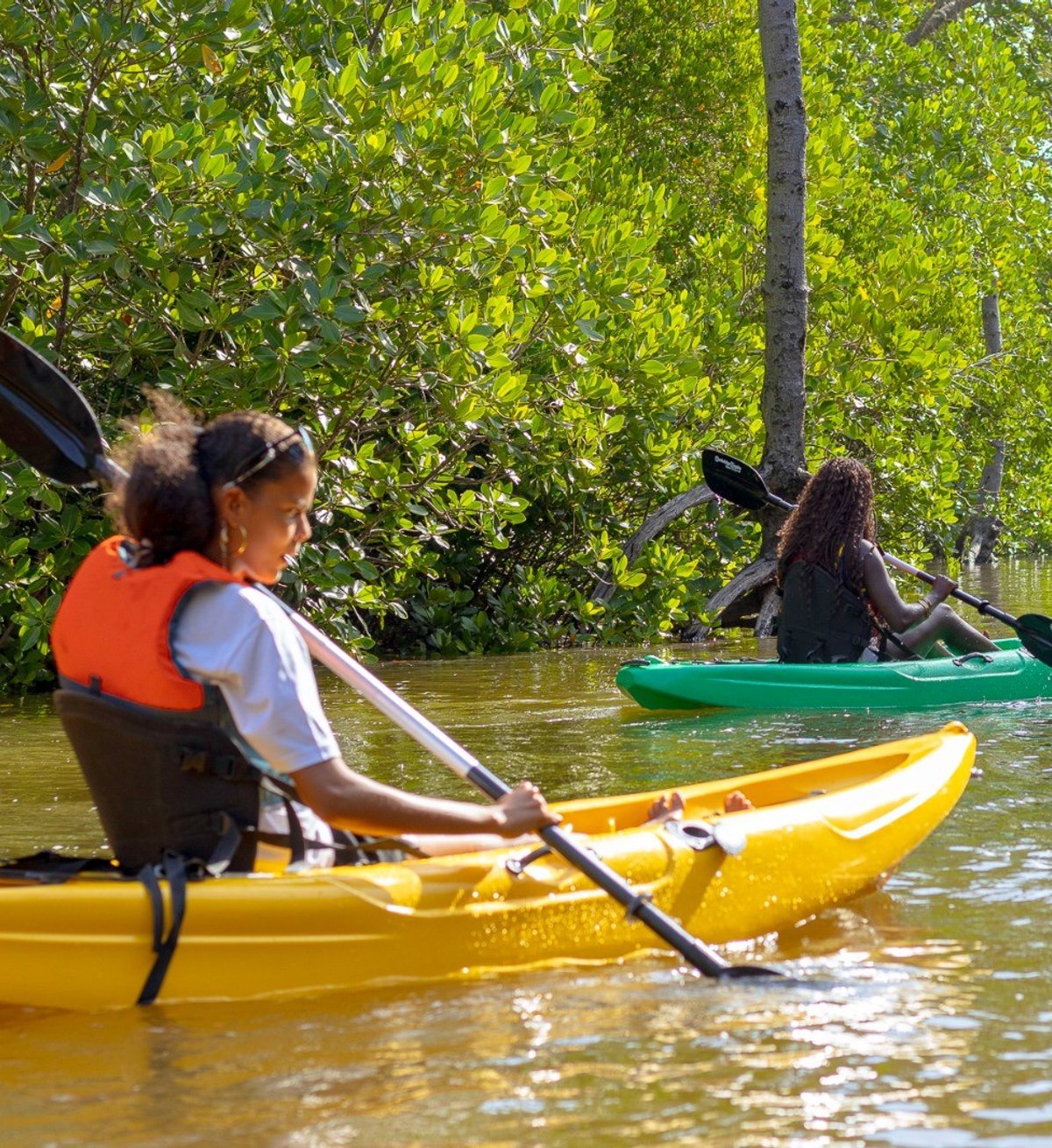 Kevin from Mkoko Explorers waving back to the camera in his kayak