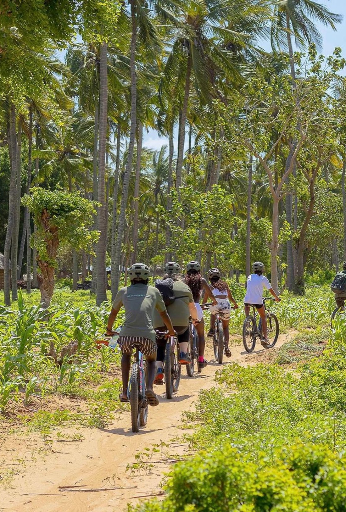 an explorer on a bike talking to a local